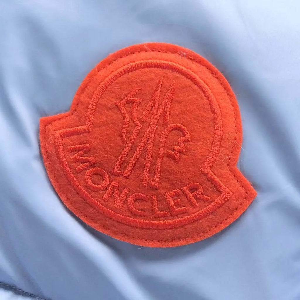 Moncler Light Blue Hooded Puffer Jacket with Orange Logo Patch